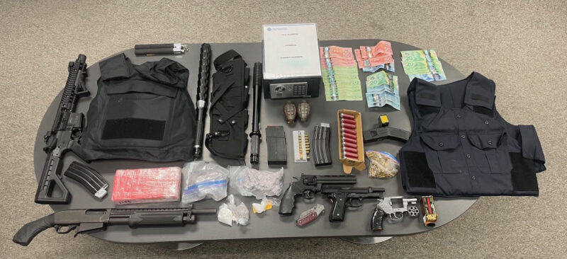 A table with money, drugs, ammunition, cash and other assorted weapons seized by NWPD.